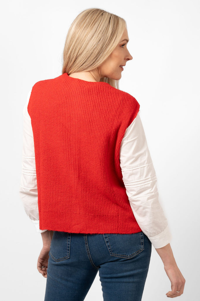 model showing the back of the red knitted tank top. the colour is plain red all over the design.