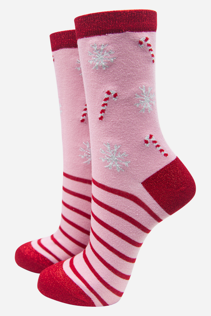 pink bamboo socks with a pattern of red candy canes, red striped and white snowflakes