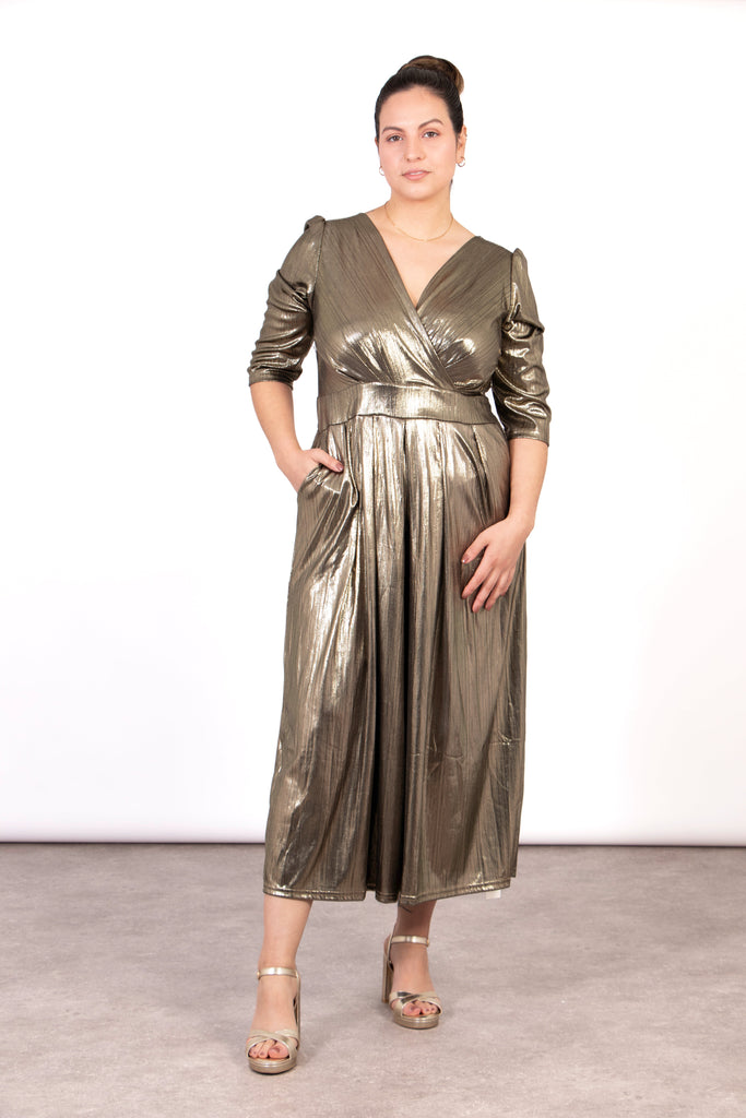 model wearing a metallic gold cropped jumpsuit with v-neck and 3/4 sleeves