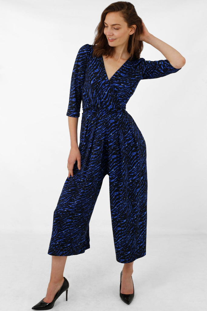 model wearing a blue zebra print jumpsuit