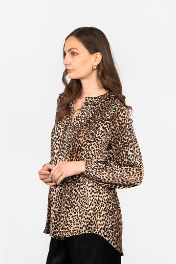 model wearing a neutral leopard print long sleeve blouse with a front neck tie and dipped hem