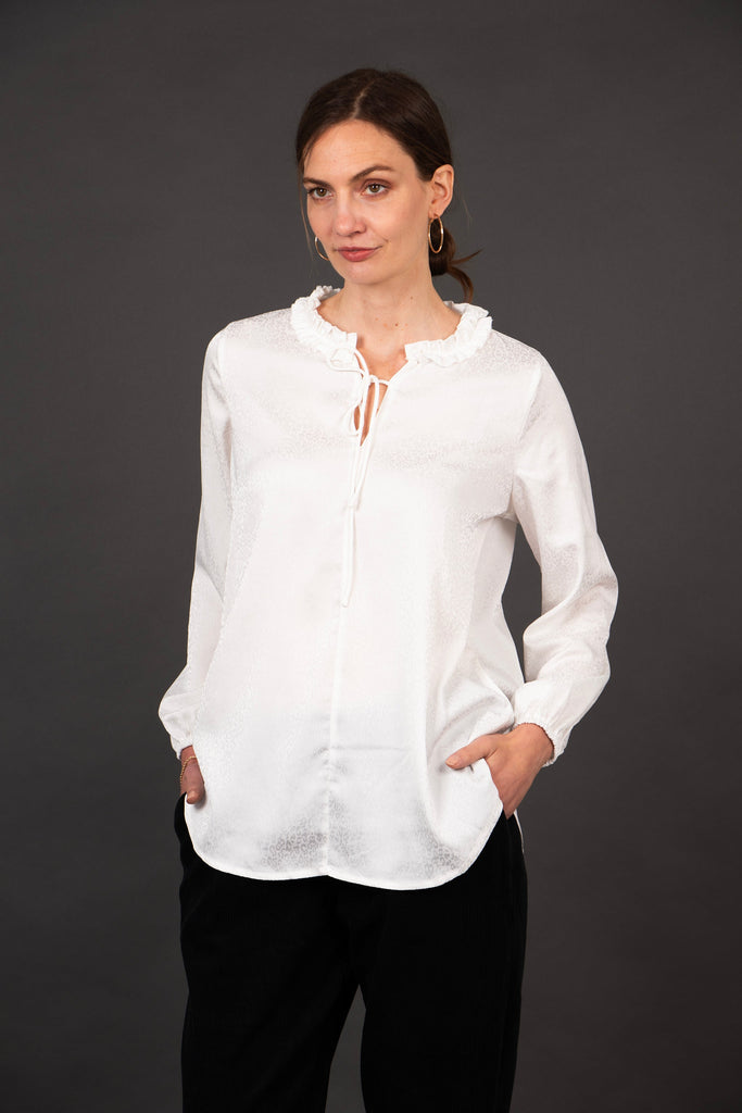 model showing the front of the blouse, the subtle white leopard print pattern is visible