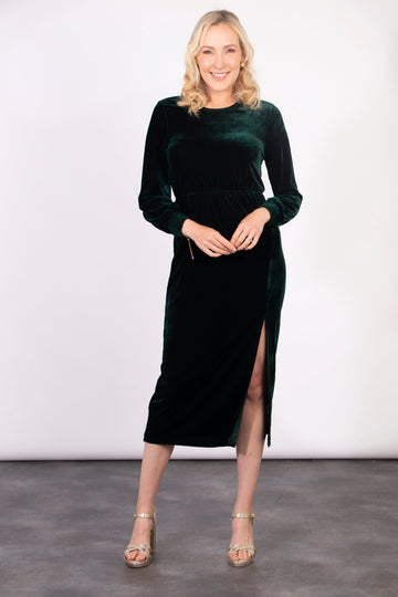 model wearing a long sleeved plain dark green  midi dress with a front split and round neck