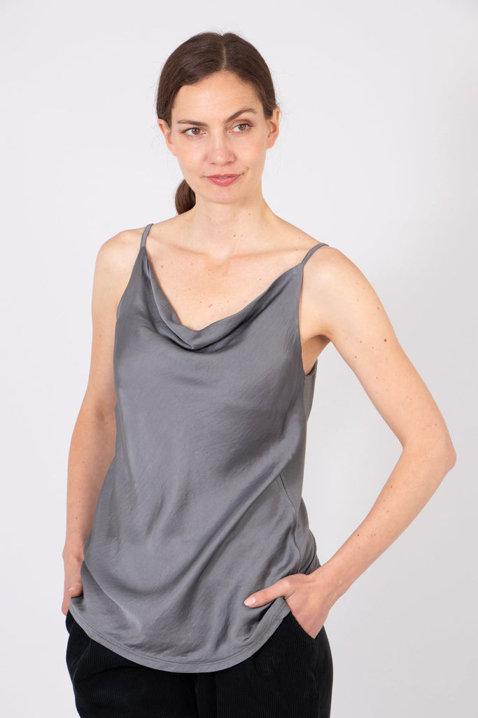 model wearing a pewter coloured silky vest top with spaghetti straps and a cowl neck