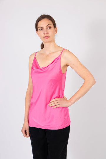 model wearing a plain raspberry pink faux silk cowl neck vest top with spaghetti straps