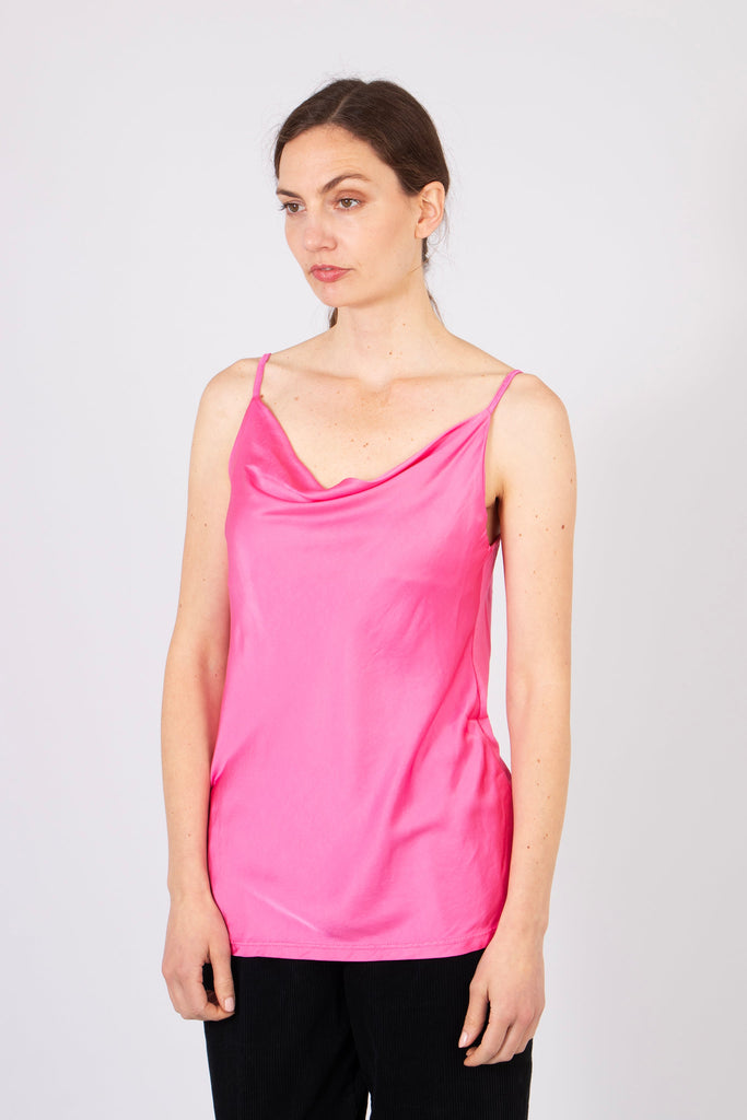 model wearing a pink cowl neck camisole tank top with thin spaghetti straps