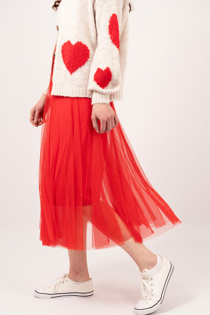 Eden-Tulle-Midaxi-Swing-Skirt-Red-Close-Up-Of-Movement-Styled-With-Cream-Heart-Print-Knit-Cardigan