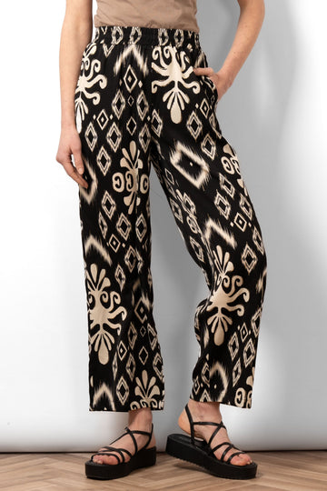 fifi-wide-leg-trousers-black-ikat-front-view-on-model-bold-pattern-pockets-elasticated-waistband