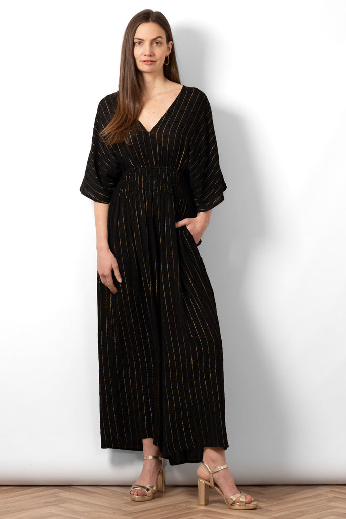 lyra-deep-v-neck-jumpsuit-black-metallic-stripe-front-on-model