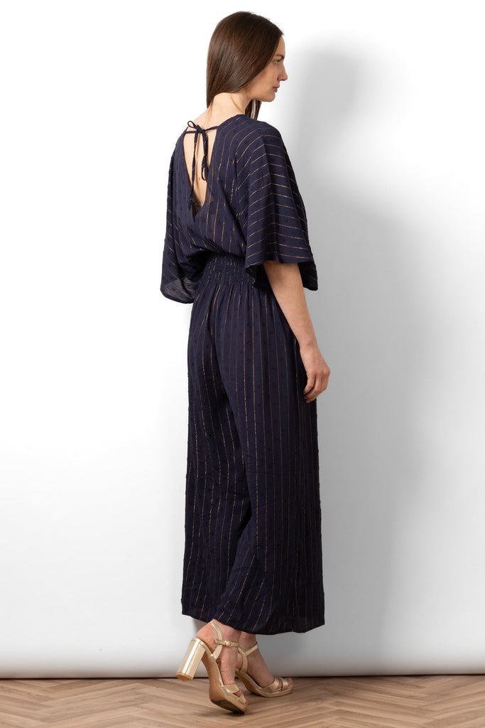 lyra-deep-v-neck-jumpsuit-navy-blue-metallic-stripe-rear-view-neck-tie-cinched-waist