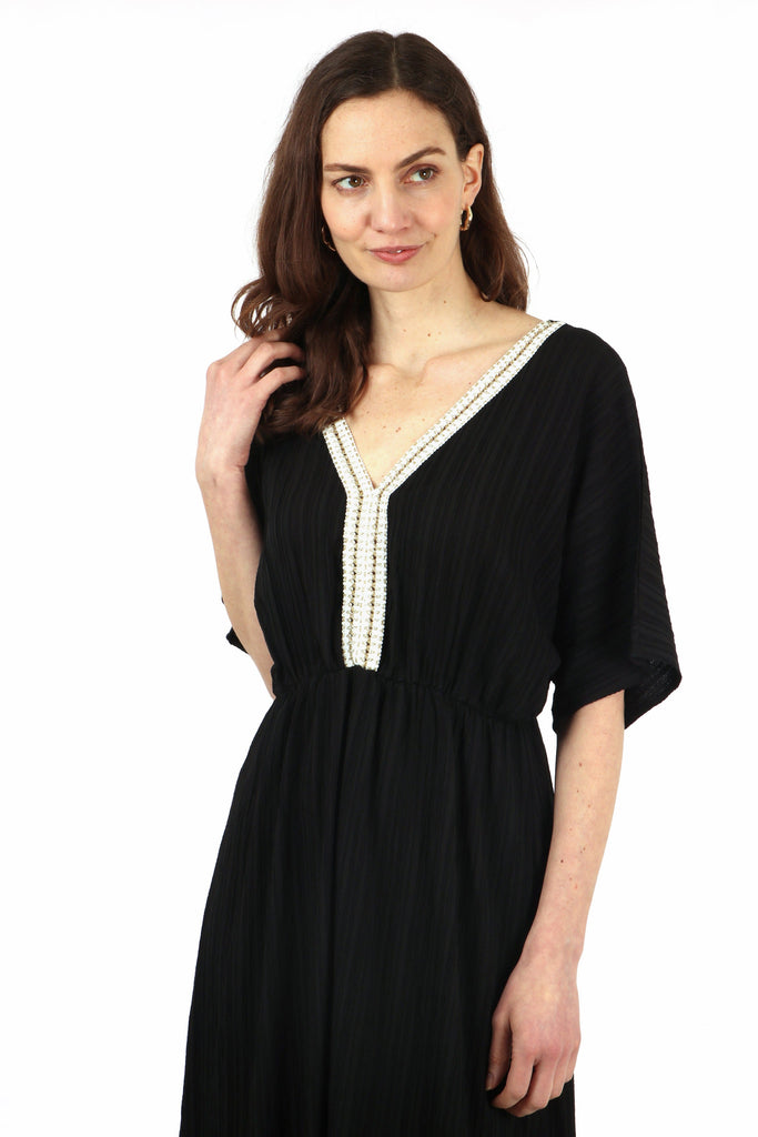 close up of the v neck and gold rope trim detail