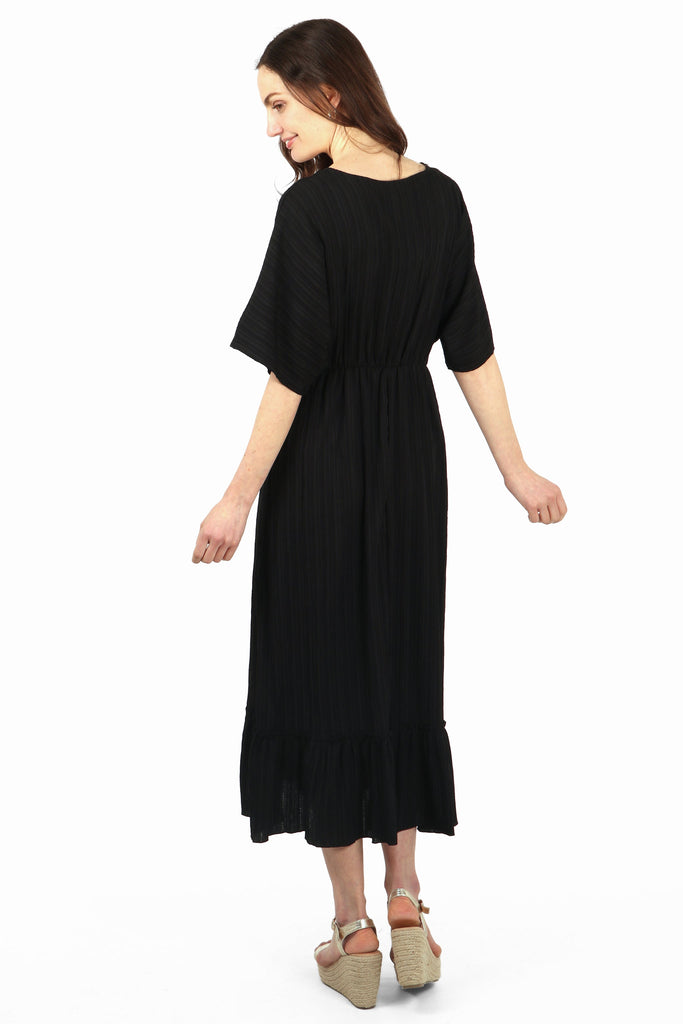 model showing the back of the kaftan dress which is plain black