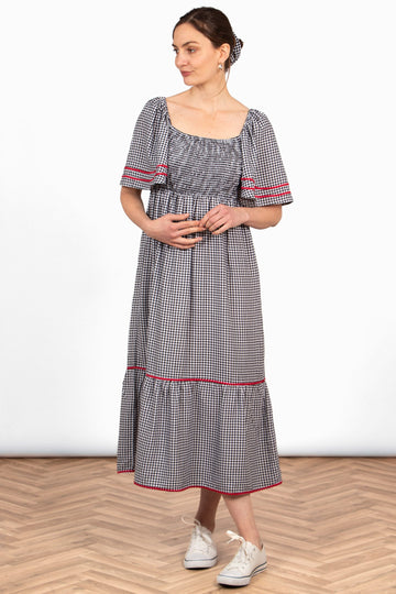 briar-milkmaid-maxi-dress-black-gingham-on-model-loose-fitting-square-neck-shirred-bodice