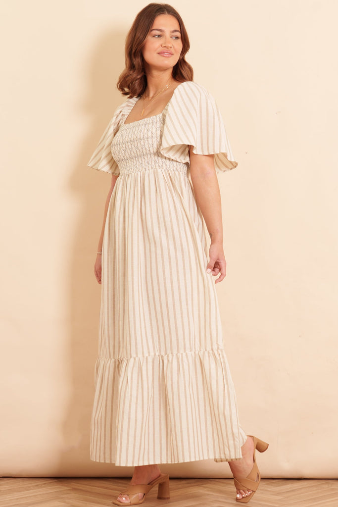 briar-milkmaid-maxi-dress-cream-striped-worn-on-model-side-view-neutral-colours