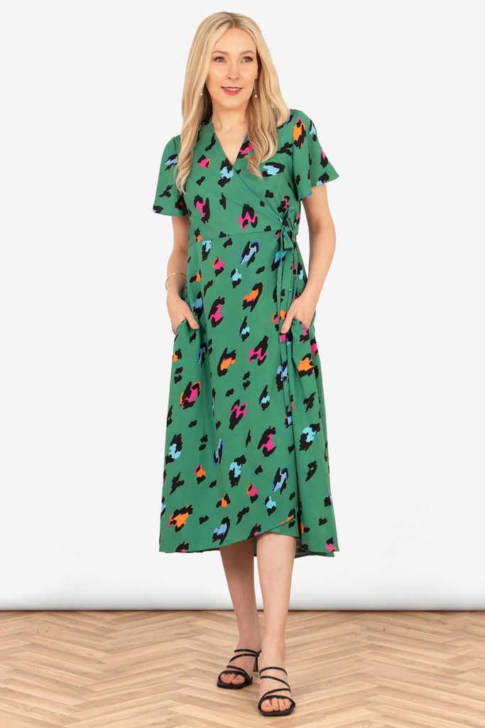 addie-short-sleeve-wrap-dress-green-multi-large-leopard-print-on-model-front-view-colourful-animal-print-patches