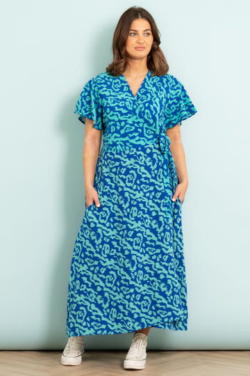 addie-short-sleeve-wrap-dress-blue-animal-print-model-front-view-showing-pockets