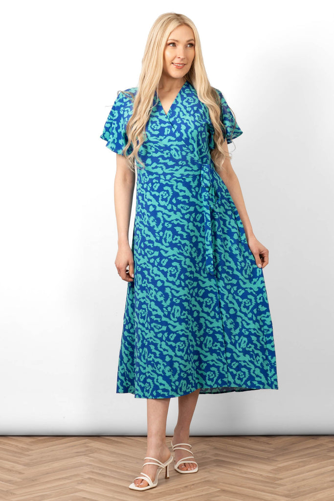 addie-short-sleeve-wrap-dress-blue-animal-print-styled-with-white-sandals