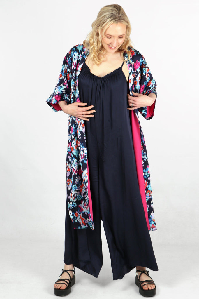 model showing the contrasting pink lining of the floral kimono robe