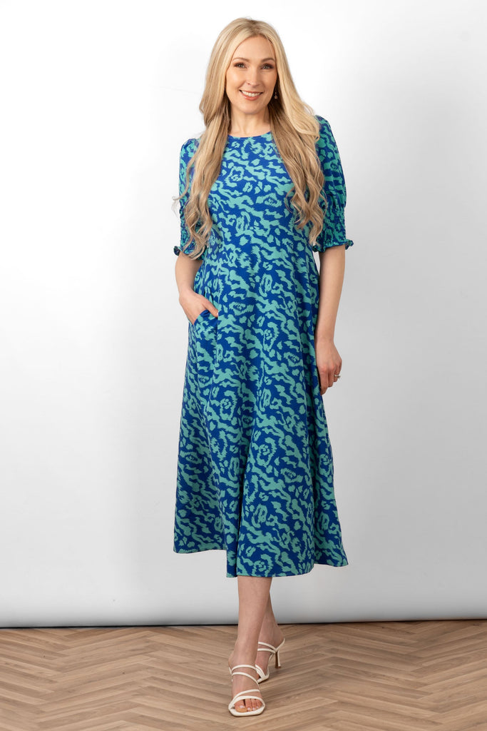 hazel-midi-tea-dress-blue-animal-print-worn-by-model-side-split-puff-sleeves-round-neck