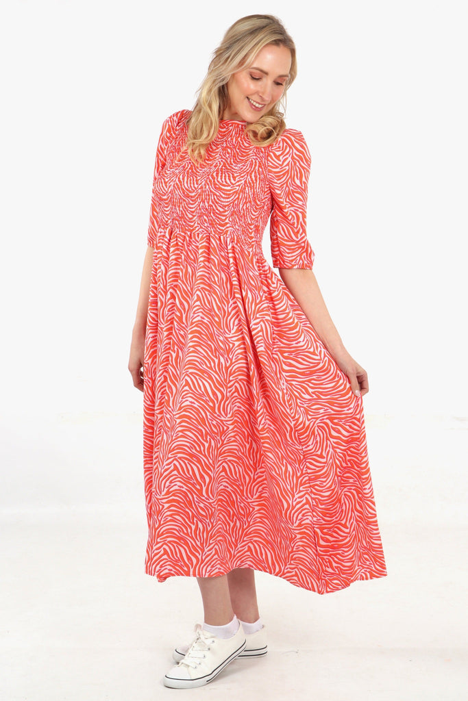 model showing the loose fitting flowy skirt on the pink zebra print maxi dress