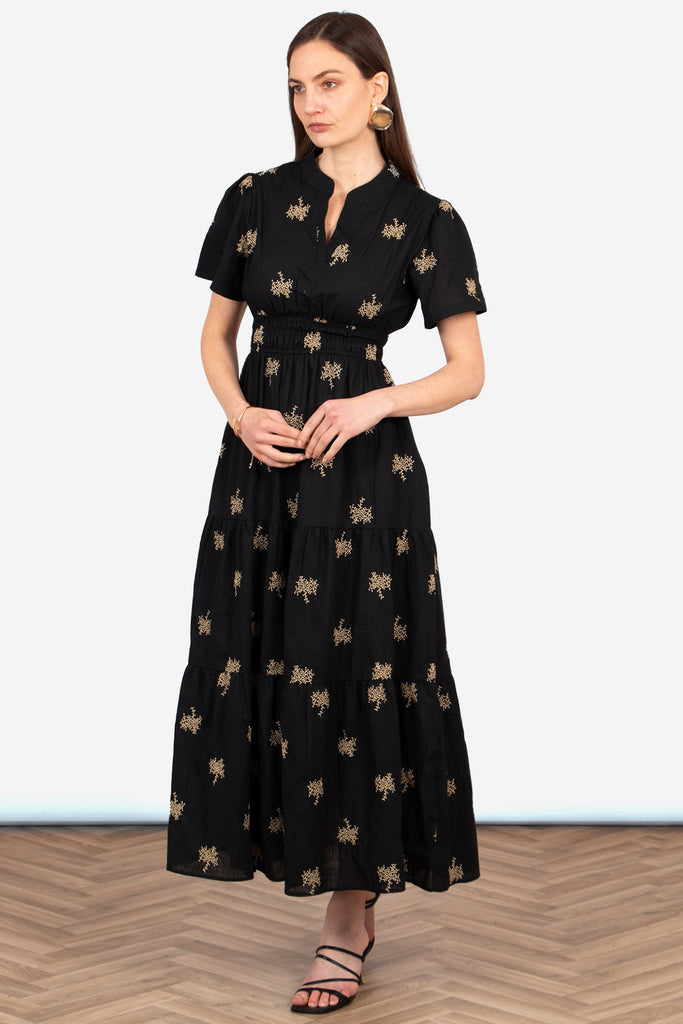 ines-tiered-cotton-maxi-dress-black-gold-embroidered-floral-front-view-model