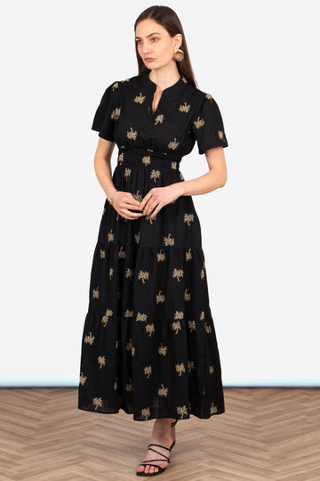 ines-tiered-cotton-maxi-dress-black-gold-embroidered-floral-front-view-model