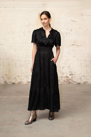 model wearing a black metallic short sleeve maxi dress 