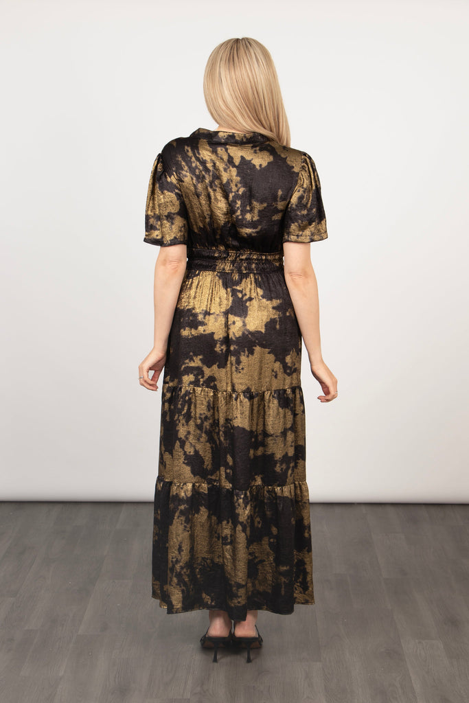 model showing the back of the dress with the shirred cinched waistline