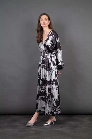 model wearing a long sleeve grey and black paint splash pattern maxi dress with a v-neck