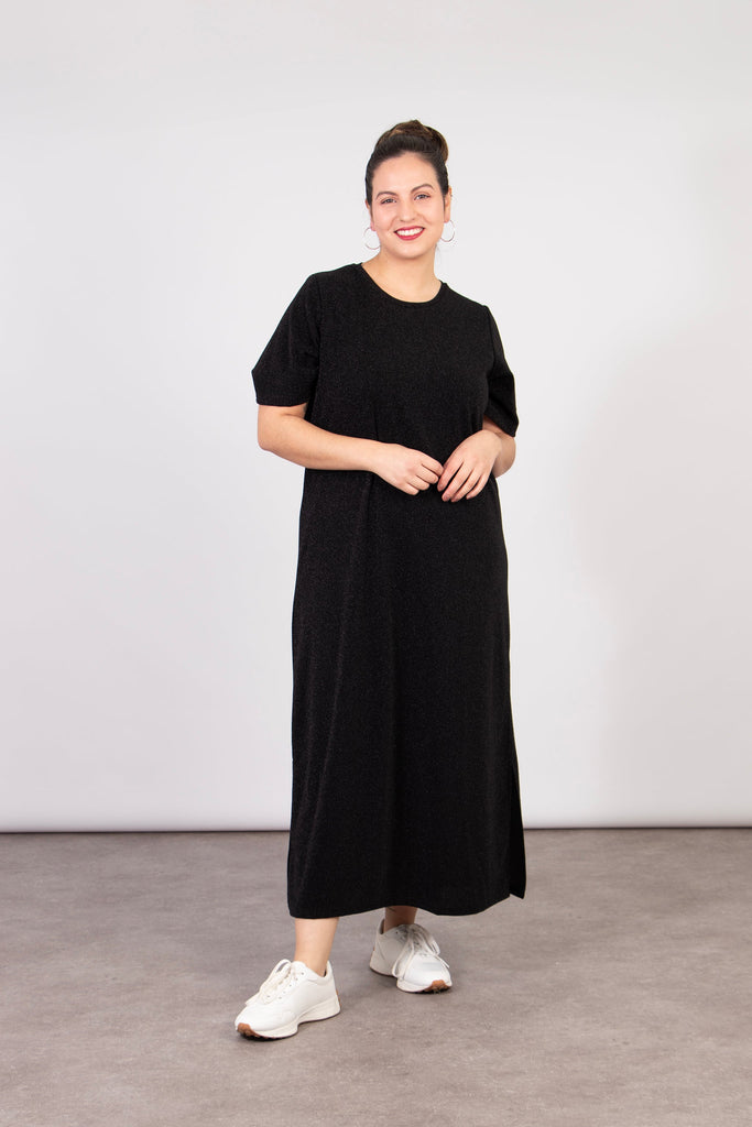 model wearing a black midaxi length t-shirt dress with subtle glitter sparkles
