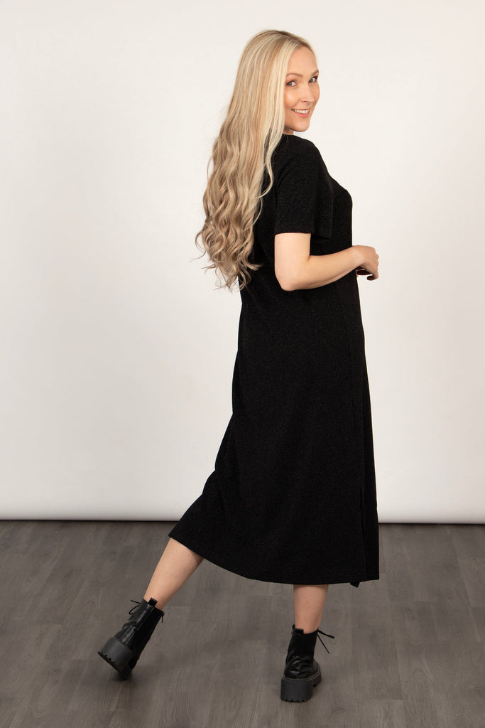 model showing the back of the black glitter t-shirt dress, showing an all over sparkle