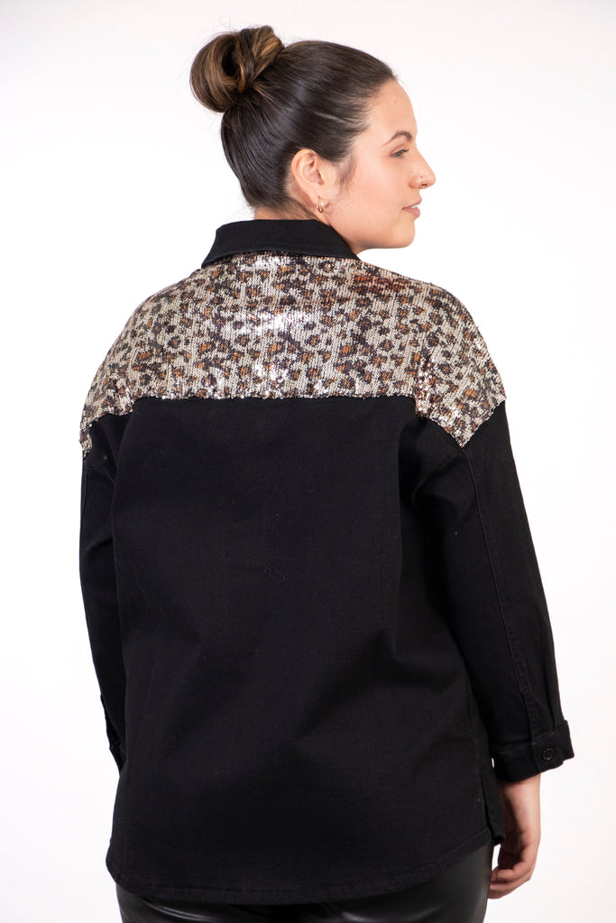 close up of the sequin leopard print panel across the shoulders of the denim shirt