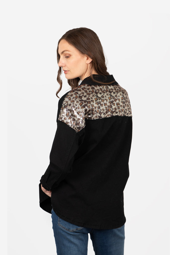 model showing the back of the shacket showing the leopard print sequin panel across the shoulders