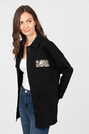 model wearing a black denim shirt with sequin leopard print pockets