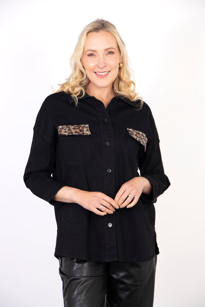 model wearing a black denim shacket with sequin leopard print pockets and a button down front