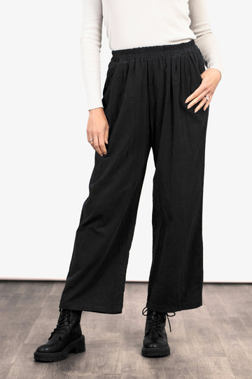 model wearing black cropped wide leg trousers