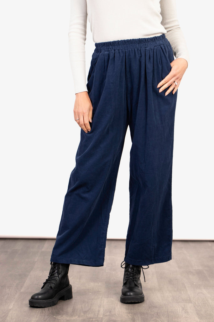 model wearing navy blue cropped wide leg trousers