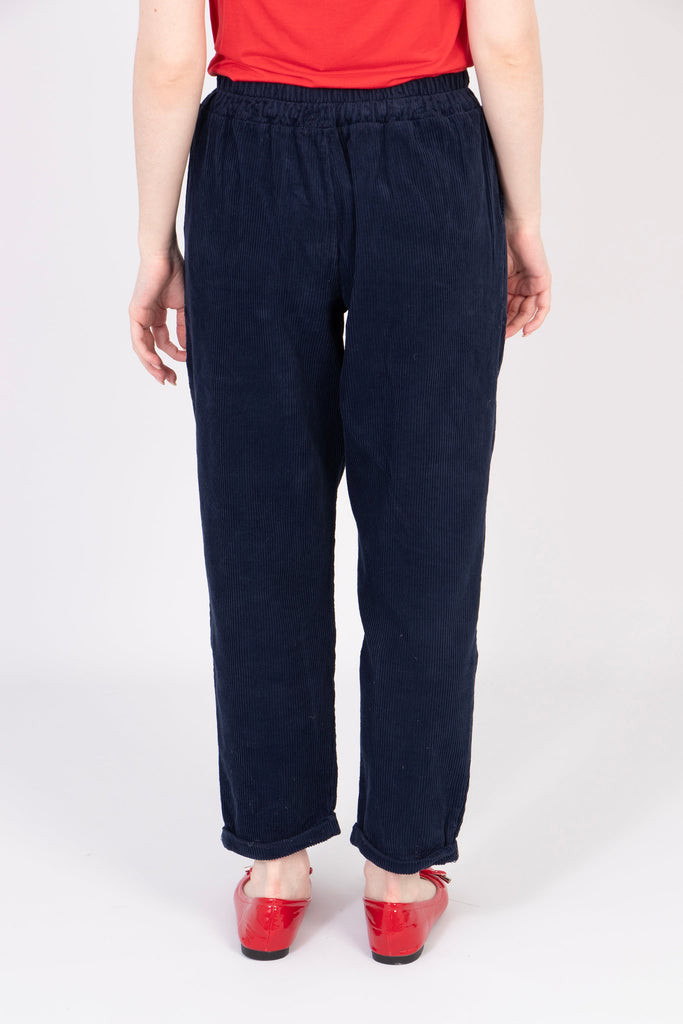 model showing the back of the trousers, the legs are tapered at the bottom and have a wide leg design