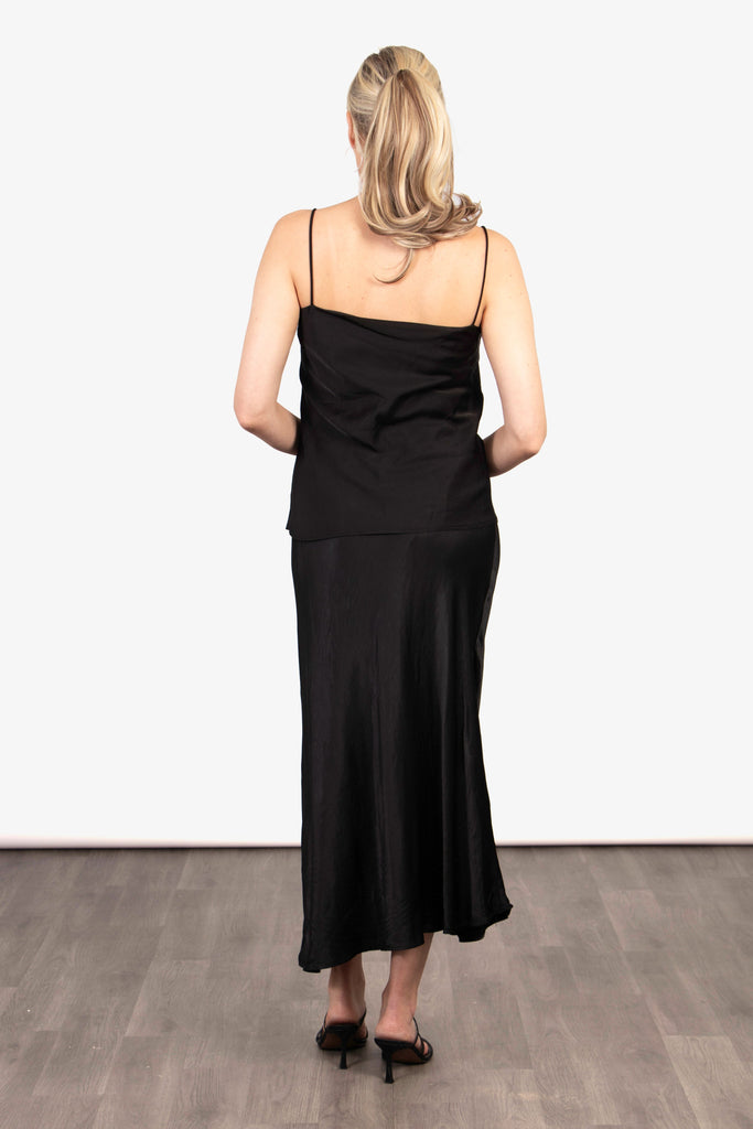 close up of the elasticated waist band on the black slip skirt