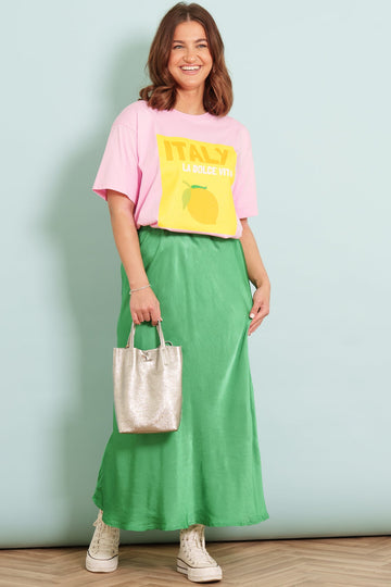 Green-Cassie-Midi-Slip-Skirt-Styled-With-Pink-itality-Graphic-Tee-And-Gold-Small-Tote-Bag