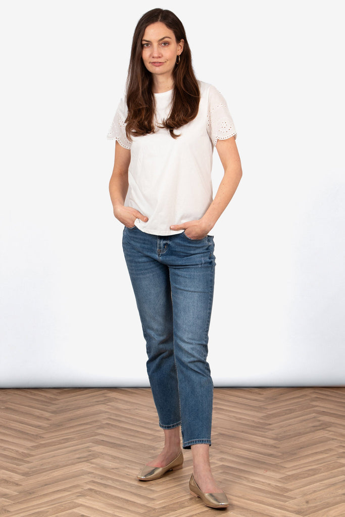 bryn-cotton-short-sleeve-top-white-broderie-anglaise-styled-with-blue-jeans-gold-flat-pumps