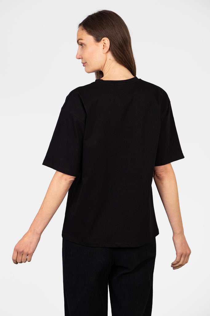 model showing the back of the t-shirt which is plain black