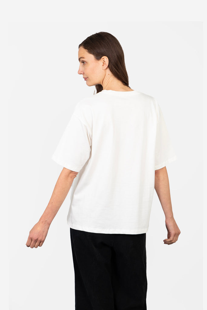 model showing the back of the white t-shirt which is plain