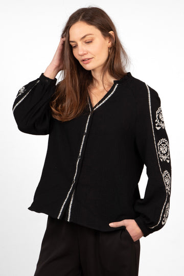 edie-v-neck-button-down-cotton-shirt-black-floral-embroidery-contrasting-trim-bold-white-flowers-sleeves