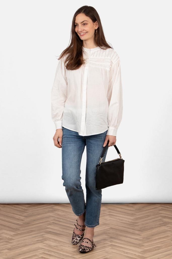 libby-long-sleeve-button-down-cotton-shirt-white-pleated-styled-on-model-paired-with-blue-jeans-black-bag-flat-shoes