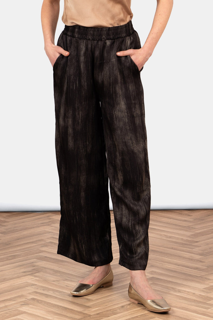 carter-wide-leg-trousers-black-gold-metallic-brushstroke-worn-on-model-front-view-pockets