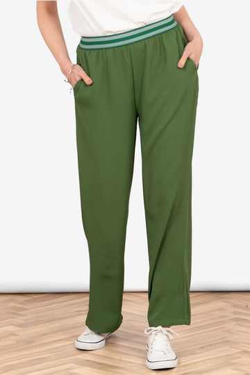 amber-wide-leg-trousers-khaki-striped-waistband-worn-on-model-front-view-pockets