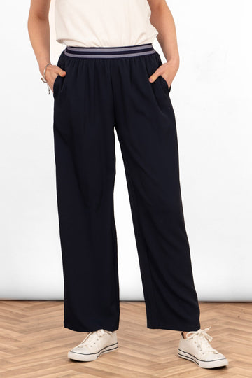 amber-wide-leg-trousers-navy-blue-model-showing-front-view-the-trousers-have-side-pockets