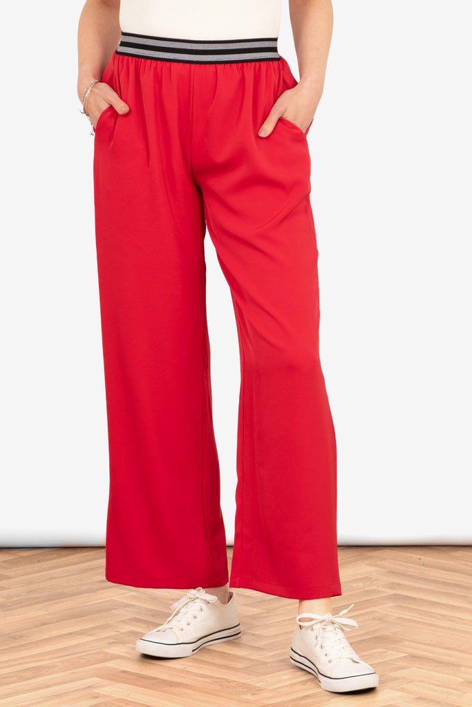 amber-wide-leg-trousers-red-side-pockets-striped-waistband