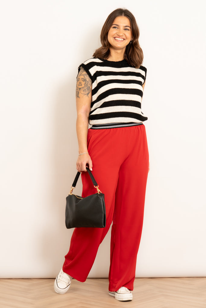amber-wide-leg-trousers-red-paired-handbag-striped top